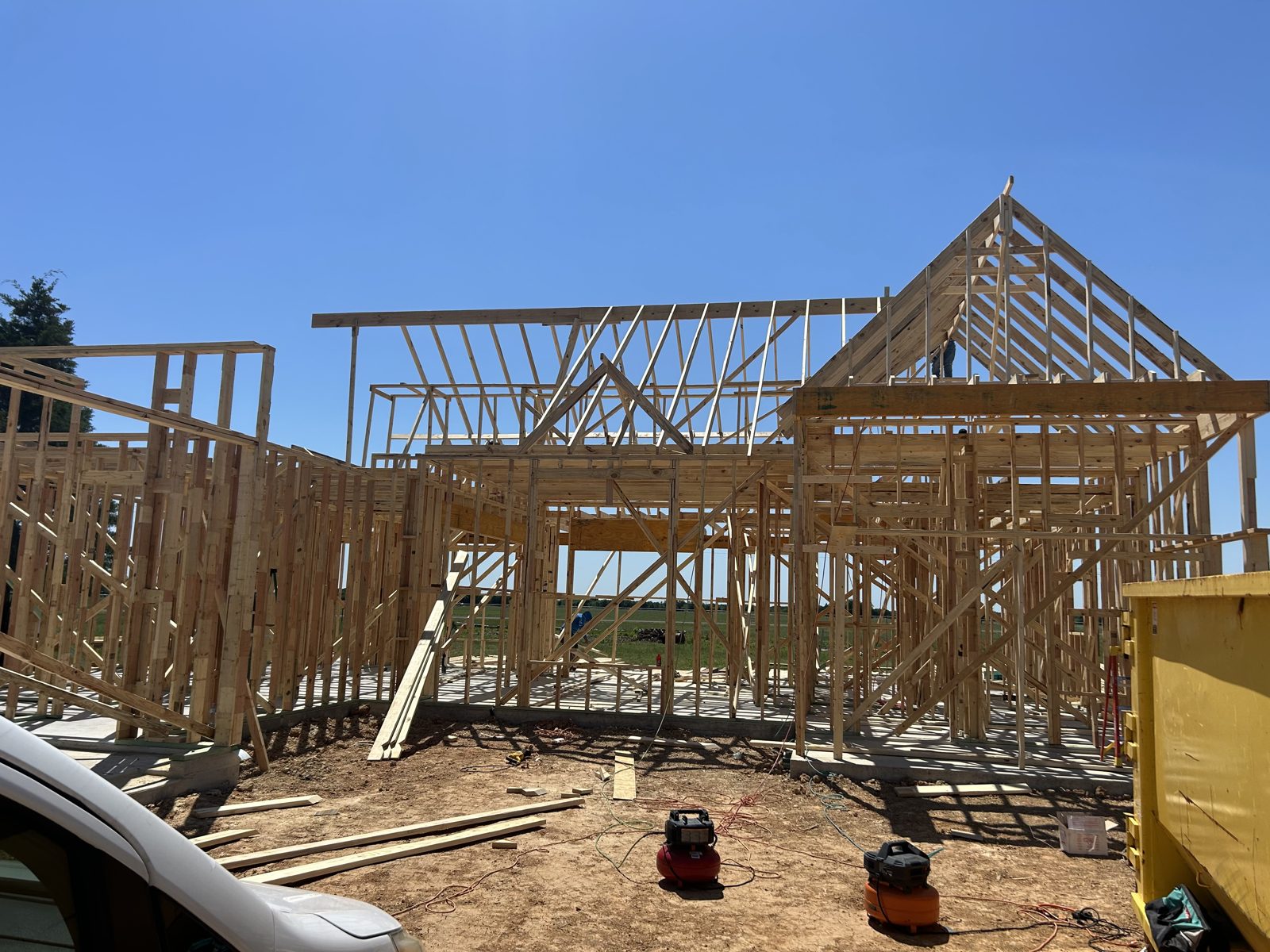 Wall framing and roof trusses going up