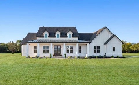 White farmhouse-style home built by Bailes Homes